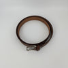 Close-up of leather design belt buckle and stitching
