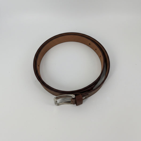 Close-up of leather design belt buckle and stitching