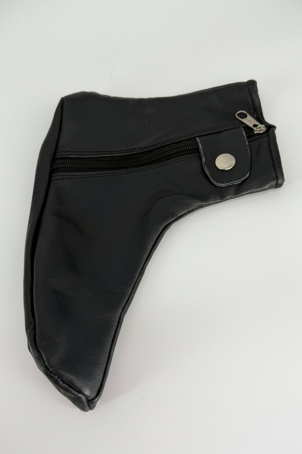Close-up of black leather shoe cover texture, stitching, zipper, and closure