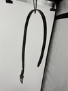 Reversible black and brown leather belt with rotating buckle in a clean product presentation