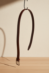 Reversible black and brown leather belt with rotating buckle in a clean product presentation