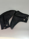 A pair of black faux leather motorcycle leg warmers with silver zipper and snap button details, displayed on a light gray background.