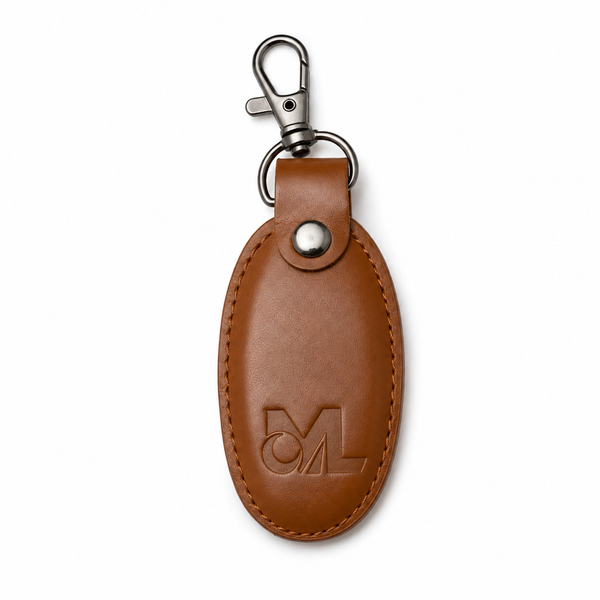 Cognac brown oval leather keychain with gunmetal clasp and embossed logo